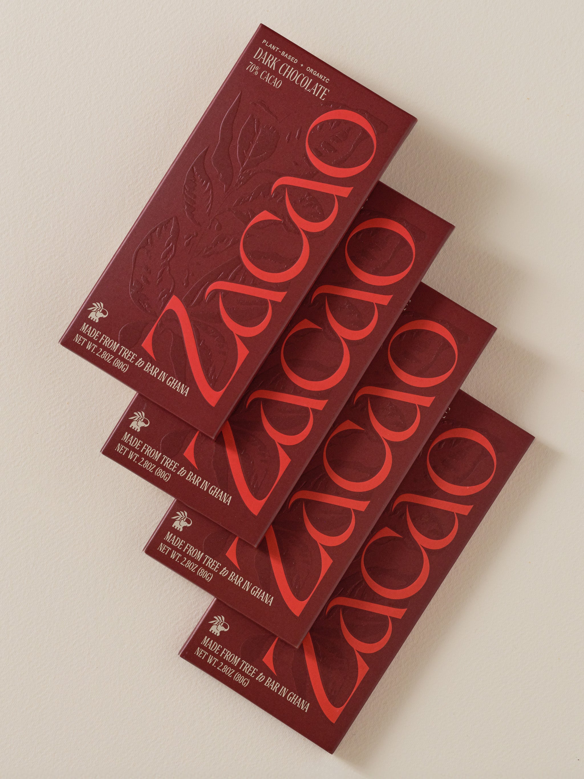 Four Zacao 70% Dark Chocolate bars arranged in a row, showcasing packaging and brand logo.