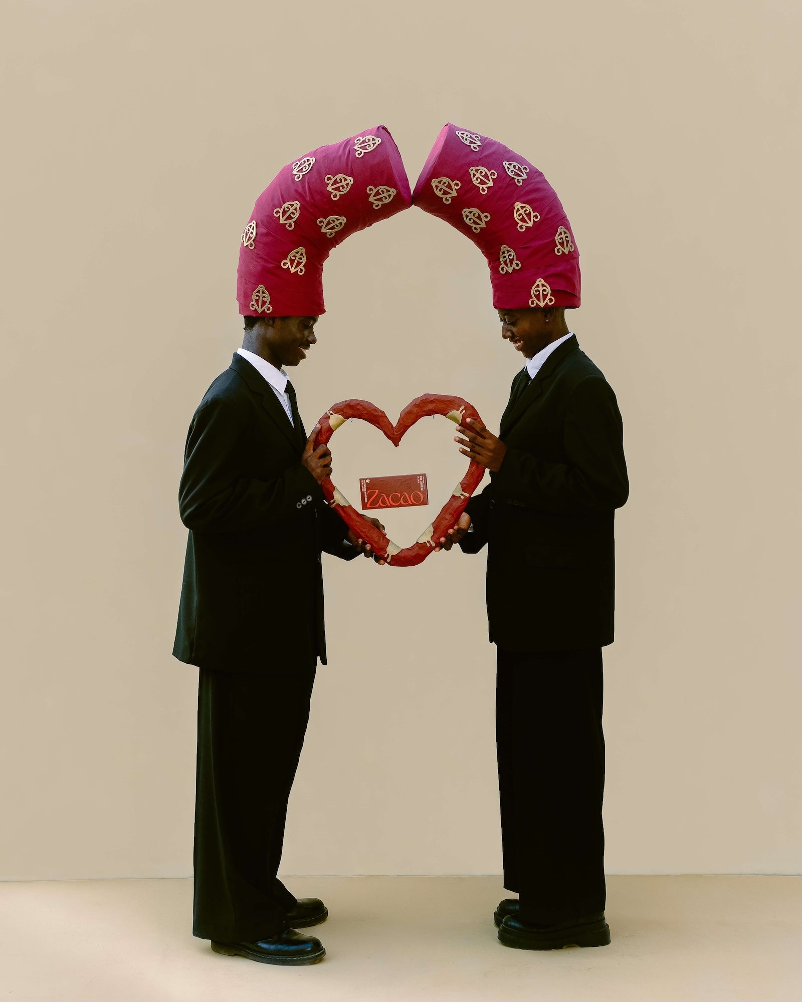 Two people holding a heart shape, with a Zacao chocolate bar floating inside the heart.